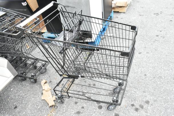 10 metal shopping carts with casters, slightly used. Black metal frames, stackable design, ideal for retail use. 