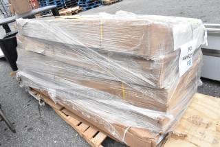 Pallet of five new scratch and dent commercial work tables wrapped in plastic, including Regency and Steelton stainless models.