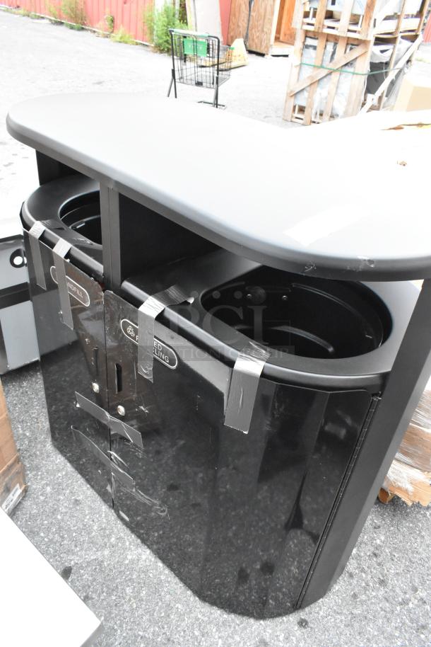 Black metal double trash can shell, brand new, with visible scratches and dents. Includes labeling for waste separation.