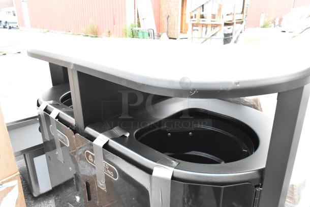 Black metal double trash can shell, brand new with visible scratches and dents, includes recycling and landfill labels.
