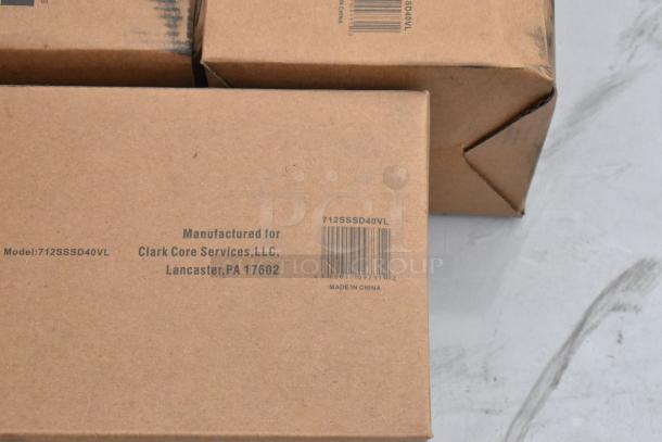 Boxes of new Lavex items, including 712SSPTDH towel dispenser and 712SSSD40VL soap dispenser, labeled and ready for auction.
