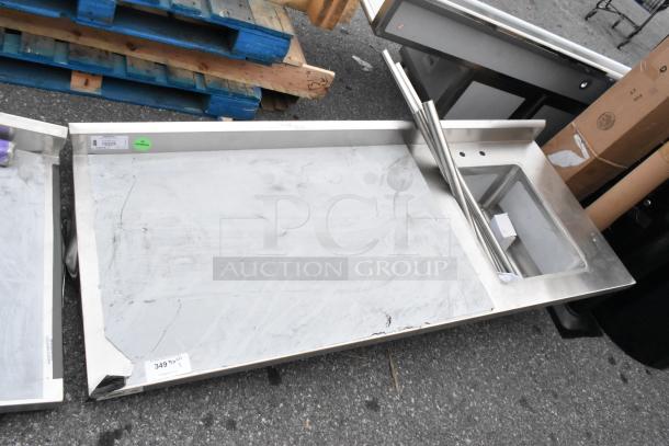 Brand new Regency 600ST3072R stainless steel table with single bay sink, scratch and dent condition, visible labels.