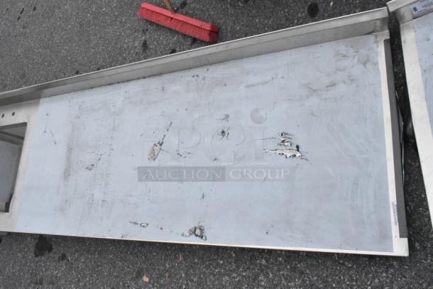 Brand new Regency 600ST3096L stainless steel table with a single bay sink, showing visible scratches and dents.