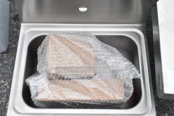Brand new Regency 600HS17KSPT 17" x 15" wall-mounted hand sink, stainless steel, bubble-wrapped, hands-free knee valve.