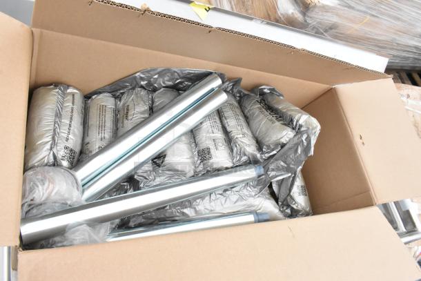 Cardboard box with metal sink legs and wrapped components for Regency 600S32424 stainless steel commercial sink.