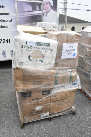 Pallet with assorted new scratch and dent items, including 2-ply napkins, translucent cups, and take-out containers, wrapped in plastic.