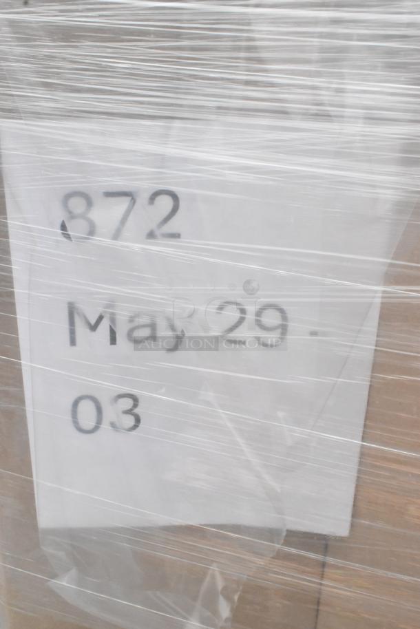 Plastic-wrapped package labeled "872, May 29-03," containing 23 new scratch and dent items like spoons and cups.