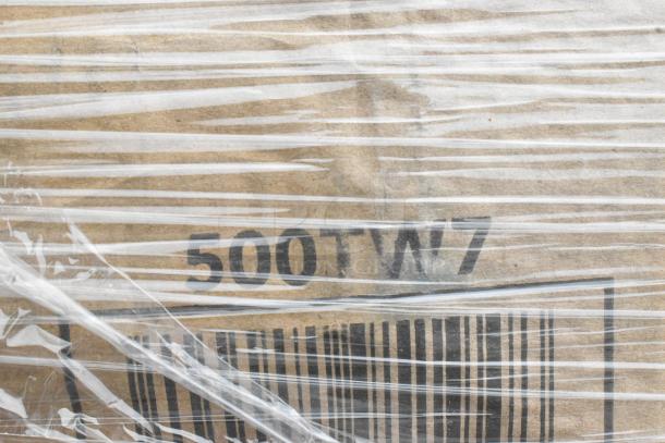 Cardboard box wrapped in plastic with "500TW7" label. Contains 22 scratch and dent items like containers and lids.