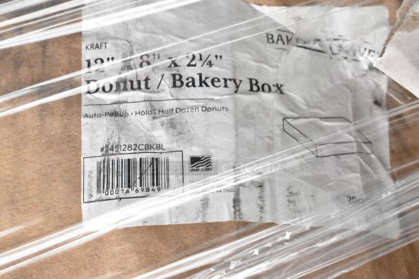 Wrapped brown packaging with label reading "12" x 18" x 2¼" Donut/Bakery Box." Barcode and "Made in USA" visible.