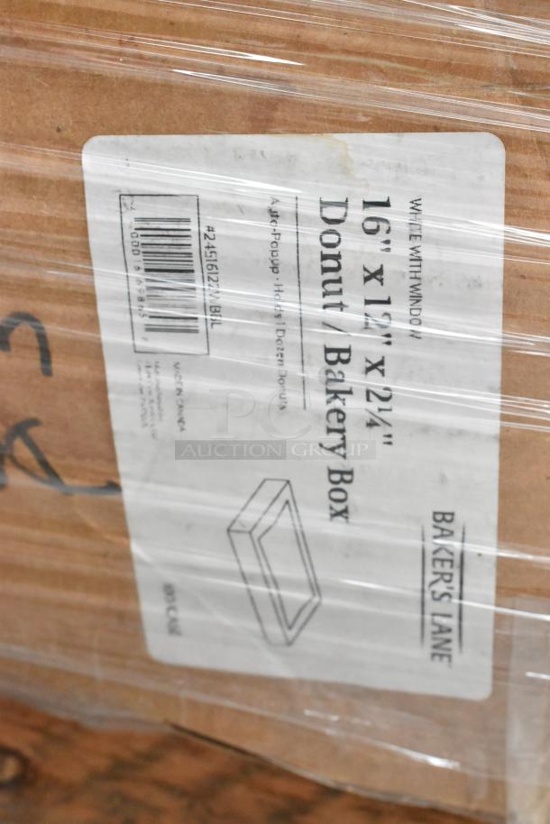 Box of Baker's Lane 16"x12"x2.14" donut bakery boxes, label visible through plastic wrap, indicating scratch and dent condition.