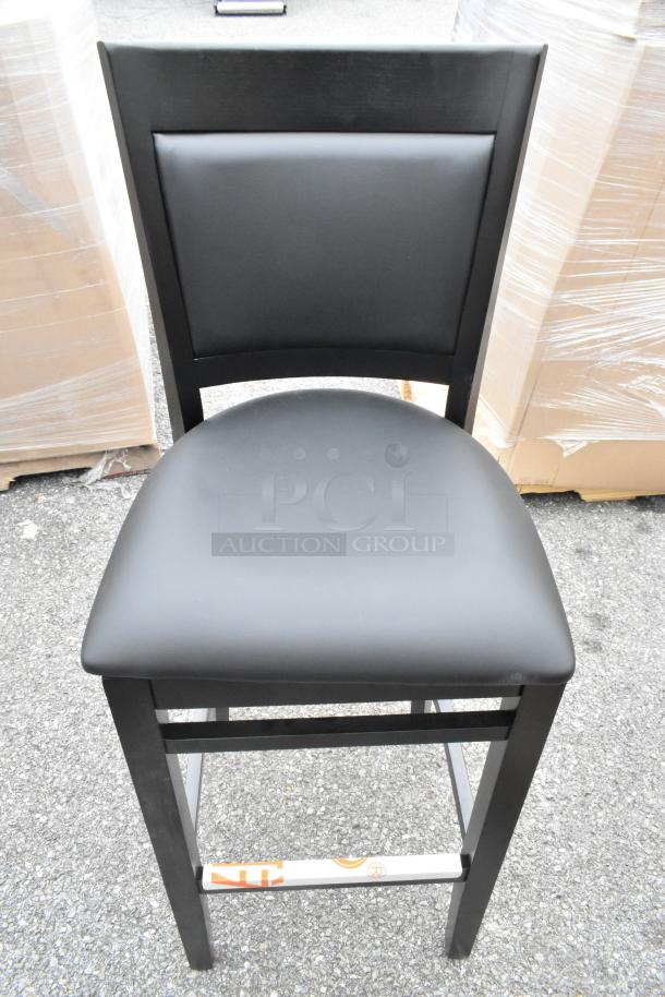 9 Lancaster Sofia bar stools, black wood finish, black vinyl seats, assembled, new scratch and dent condition.