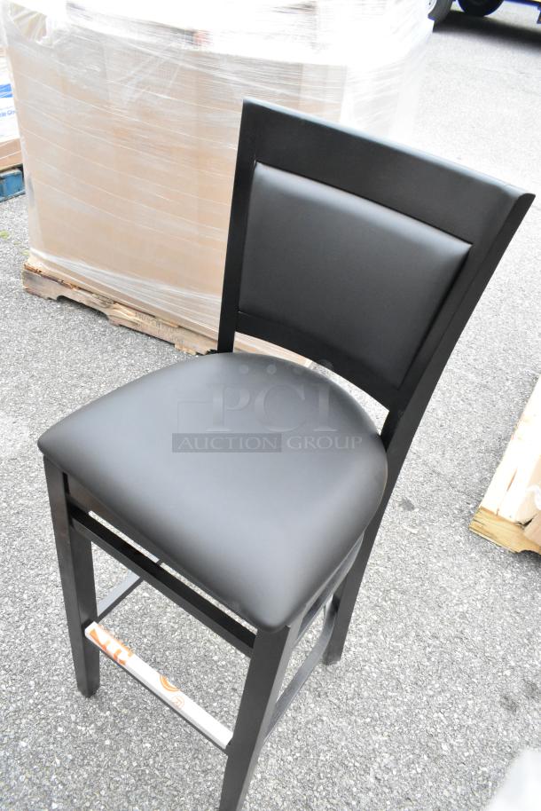 Black wooden bar stool with black vinyl seat, Lancaster Table & Seating Sofia model. New, scratch and dent condition.