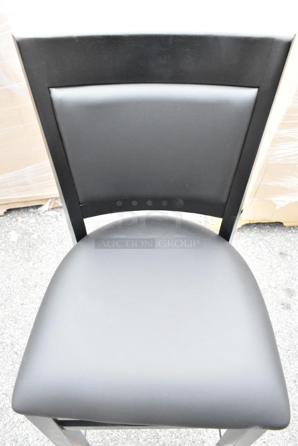 9 new Lancaster Table & Seating Sofia black wood bar stools with black vinyl seats, assembled. Scratch and dent condition.