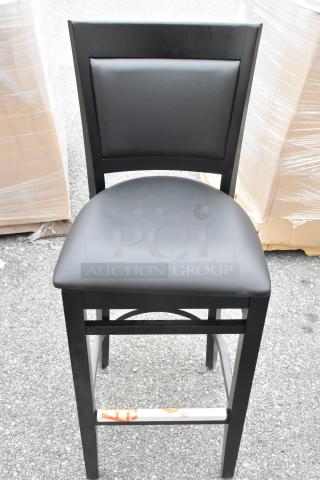 Brand new Lancaster Table & Seating Sofia bar stool, black wood finish, black vinyl seat, assembled. Scratch and dent condition.