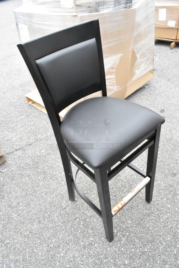 8 brand new Lancaster Sofia black wood bar stools, black vinyl seat, assembled, minor scratches and dents.