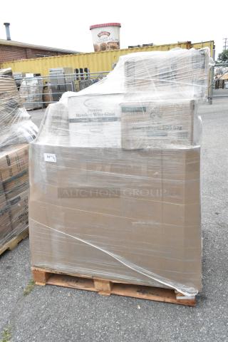 Pallet of 30 scratch and dent items wrapped in plastic, including paper towels, plates, and cups. Boxes labeled "Premium Stemless Wine Glass."