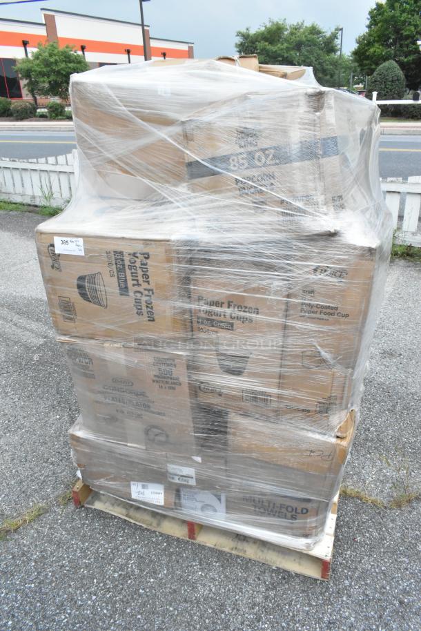 Wrapped pallet with assorted items including trash bags, food cups, and towels. Boxes labeled "Paper Frozen Yogurt Cups" and "Multi-Fold Towels."