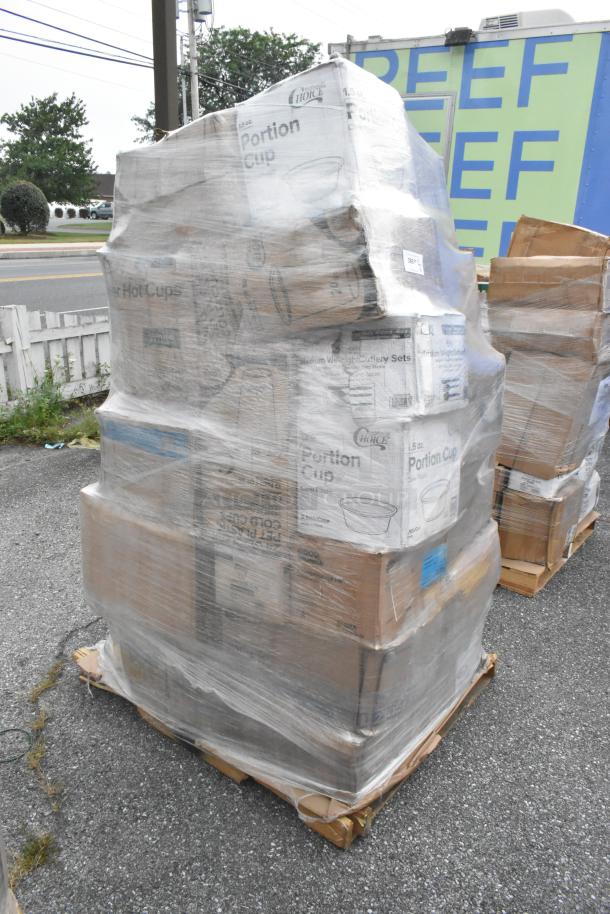 Plastic-wrapped pallet of scratch and dent items including trash bags, towels, cups, liner sheets, plasticware. Boxes display "Choice Portion Cup" branding.