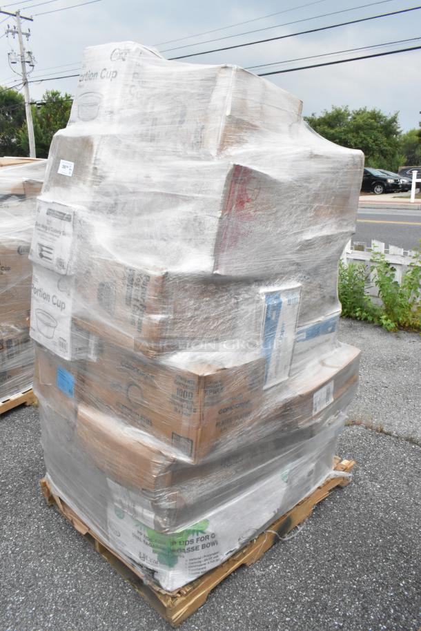 Pallet of assorted new items wrapped in plastic. Includes trash bags, towels, hot cups, and more. Boxes labeled for contents.