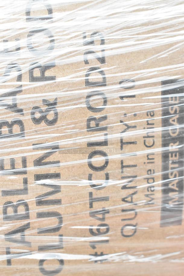 Shrink-wrapped cardboard box labeled "TABLE BASE COLUMN & ROD". Marked "QUANT: 10" and "Made in China". Part of scratch and dent auction lot.
