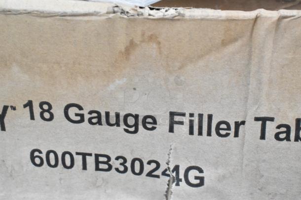 Cardboard box with "18 Gauge Filler Tab." text, item code 600TB3024G. Box shows signs of wear and tear.