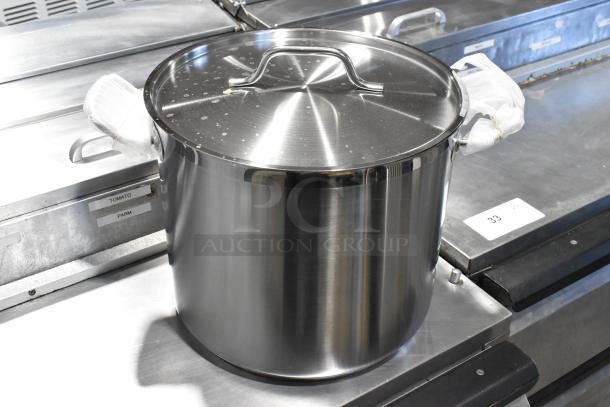 Four metal items: three stock pots and one colander/steam pot, stainless steel, used condition, auction item.