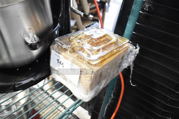 Amber poly 1/6 size drop-in bin lids, brand new with minor scratches and dents, in packaging with label showing quantity 146.