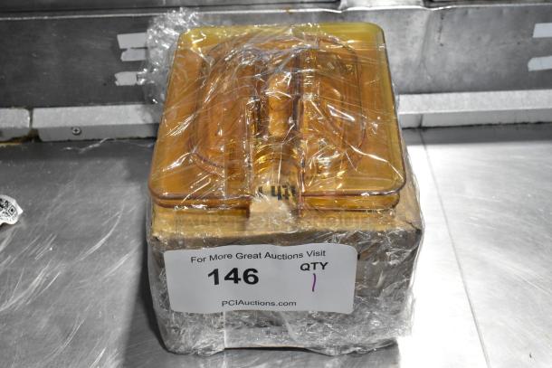 Amber poly 1/6 size drop-in bin lids, brand new, scratch and dent condition, wrapped, labeled "Lot 146".