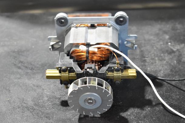 Bison 122485-00 motor component, brand new condition with visible copper wiring and metal casing, ideal for repair or replacement.
