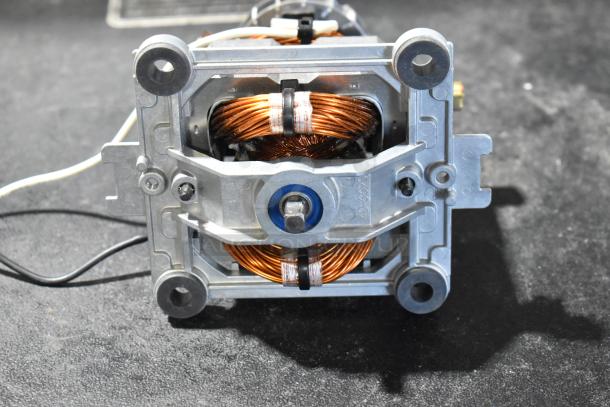 Alt Text: Bison 122485-00 motor component, new, showing copper wiring and metallic frame, slight scratches visible.