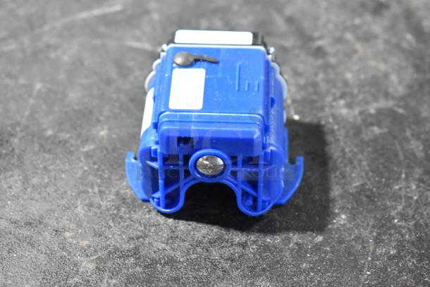 Bison 122485-00 component, new with minor scratches. Blue casing, visible mounting screw, on dark surface.