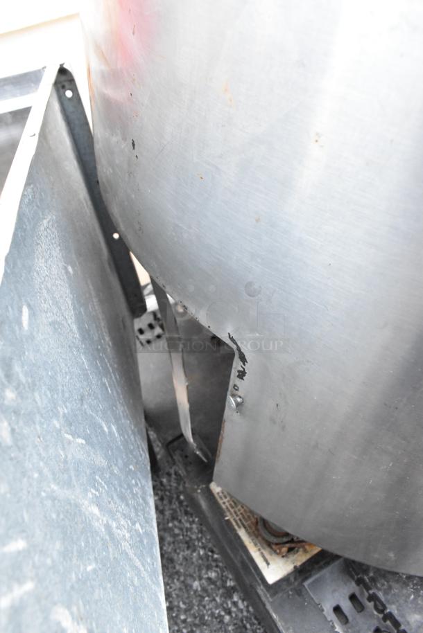 Stainless steel kettle with visible wear and rust spots on the surface. Ideal for refurbishment or parts.