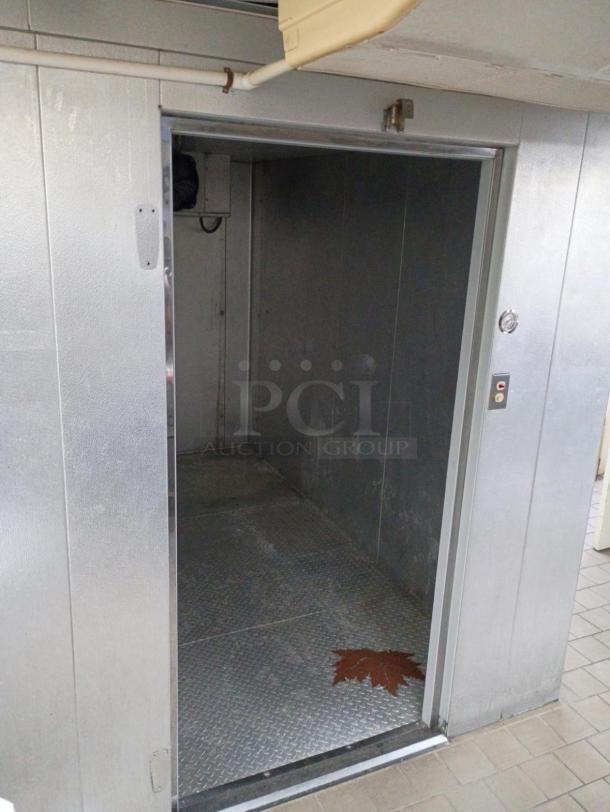 Harford 6'x12' self-contained walk-in cooler box with floor, compressor, evaporator fan. Silver exterior, pre-removal photo.