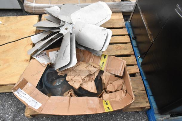 12-item auction lot including Igloo IRF32BK mini cooler, metal fan blades, plastic strip curtain rolls. Items on a pallet.