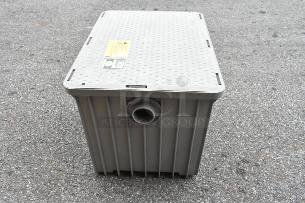 BRAND NEW Endura 3950A03 grease trap, 100 lb, 50 GPM, 3" hub. Scratch and dent condition. Tags show model and capacity.