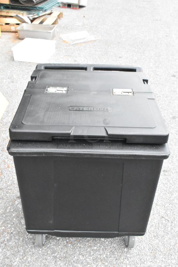Brand new CaterGator 215IB125BK black mobile ice bin, 125 lb capacity, flip lid, minor scratches, mobile wheels.