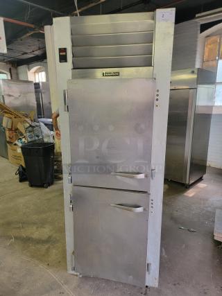 Traulsen G12000 commercial reach-in freezer, stainless steel, vertical design, visible control panel, professional-grade condition.