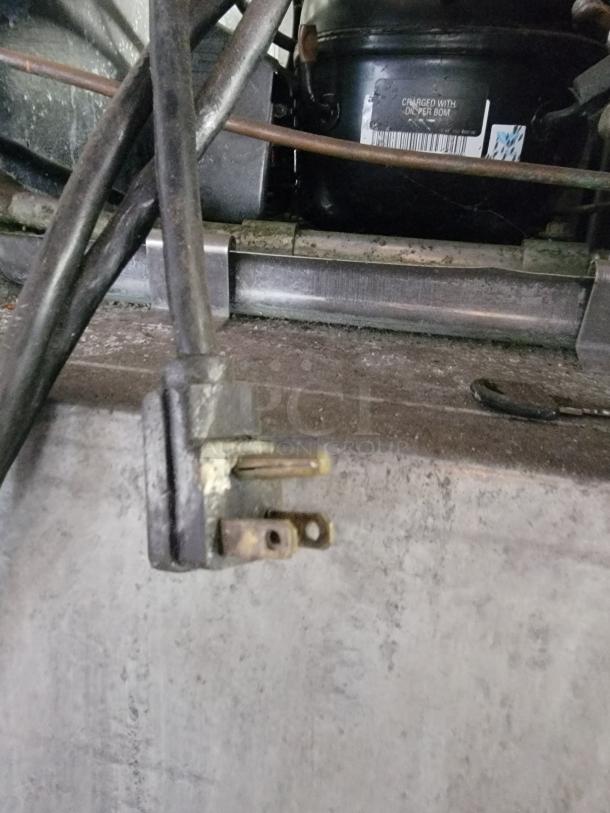 Electrical plug and wiring for Traulsen G12000 Commercial Reach-In Freezer, model details barely visible.