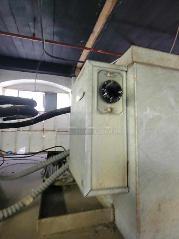 Traulsen AR1-2-32 LPUT pass-through refrigerator with control panel. Exterior shows signs of wear. Ideal for commercial kitchens.