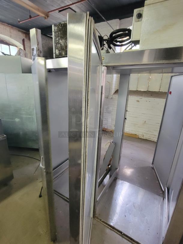 Traulsen AR1-2-32 LPUT two-door pass-through refrigerator; sturdy, stainless steel, ideal for high-traffic kitchens.