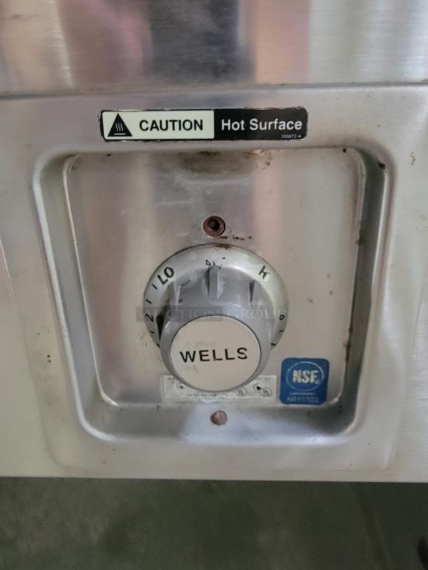 Wells SS-OULTD heated buffet table control panel with temperature dial and NSF certification. Caution: Hot Surface label.