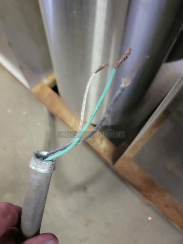 A close-up of exposed wiring from a Wells SS-OULTD commercial heated buffet table. Wiring needs repair.