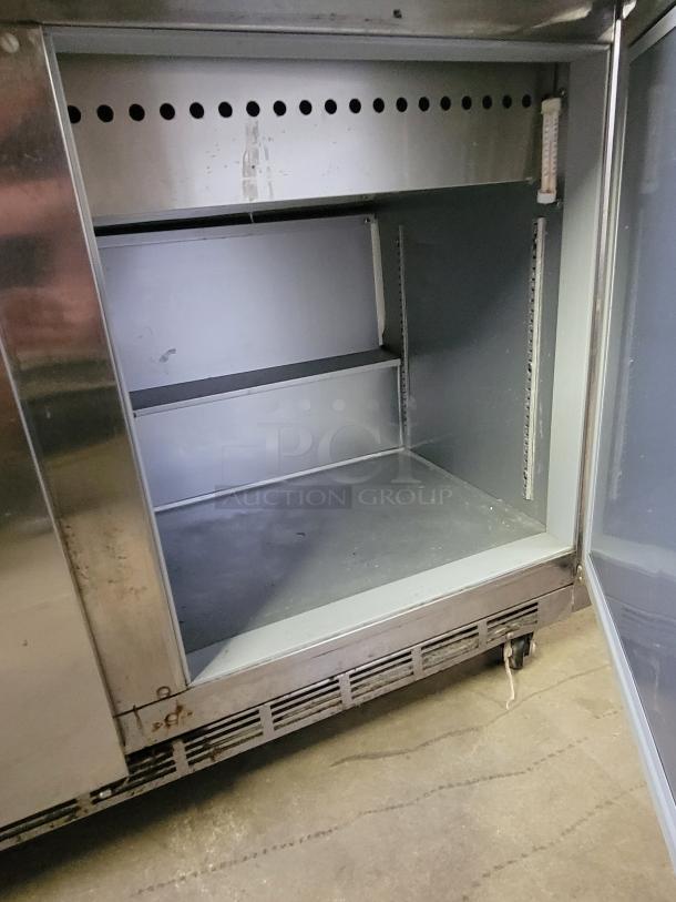 Beverage-Air Mega Top Prep Table model SPE72HC-30M, open door view, showing interior shelving and a thermometer. Slight rust on frame.