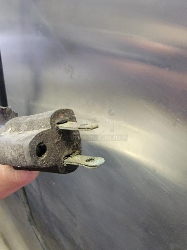 Plug of a Carter-Hoffmann heated holding cabinet model THU000000A, showing worn prongs and signs of use.