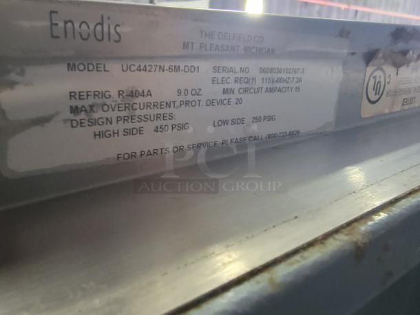 Delfield UC4427N-6M-DD1 refrigerated prep table label, showing model, serial number, refrigerant details, and contact information.