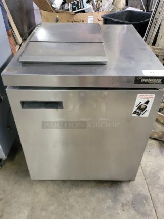 Delfield UC4427N-6M-DD1 refrigerated prep table in stainless steel, with top prep surface and refrigerated door compartment, good condition.