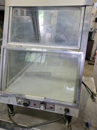 Merco 1220-1P countertop food warmer with glass display, adjustable heat controls, in used condition. Ideal for food service.