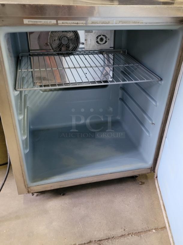 Manitowoc Delfield 436-STAR2 undercounter refrigerator. Compact, gray interior, single shelf, fan, visible labels. Good condition.