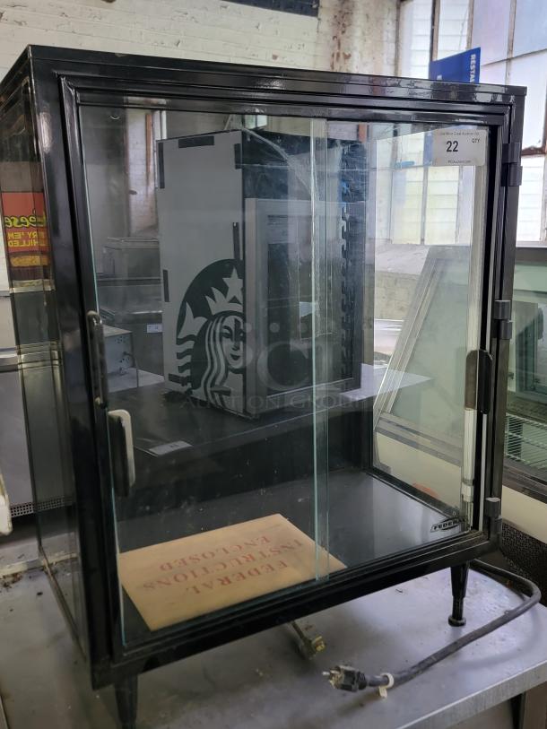 Federal Industries lighted display case model SB28SS with sleek black frame and clear glass doors. Ideal for cafes or bakeries.