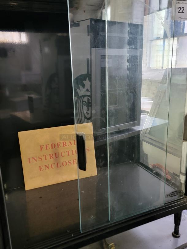 Federal Industries SB28SS lighted display case with black frame, clear glass doors. Includes instructions. Ideal for cafes.